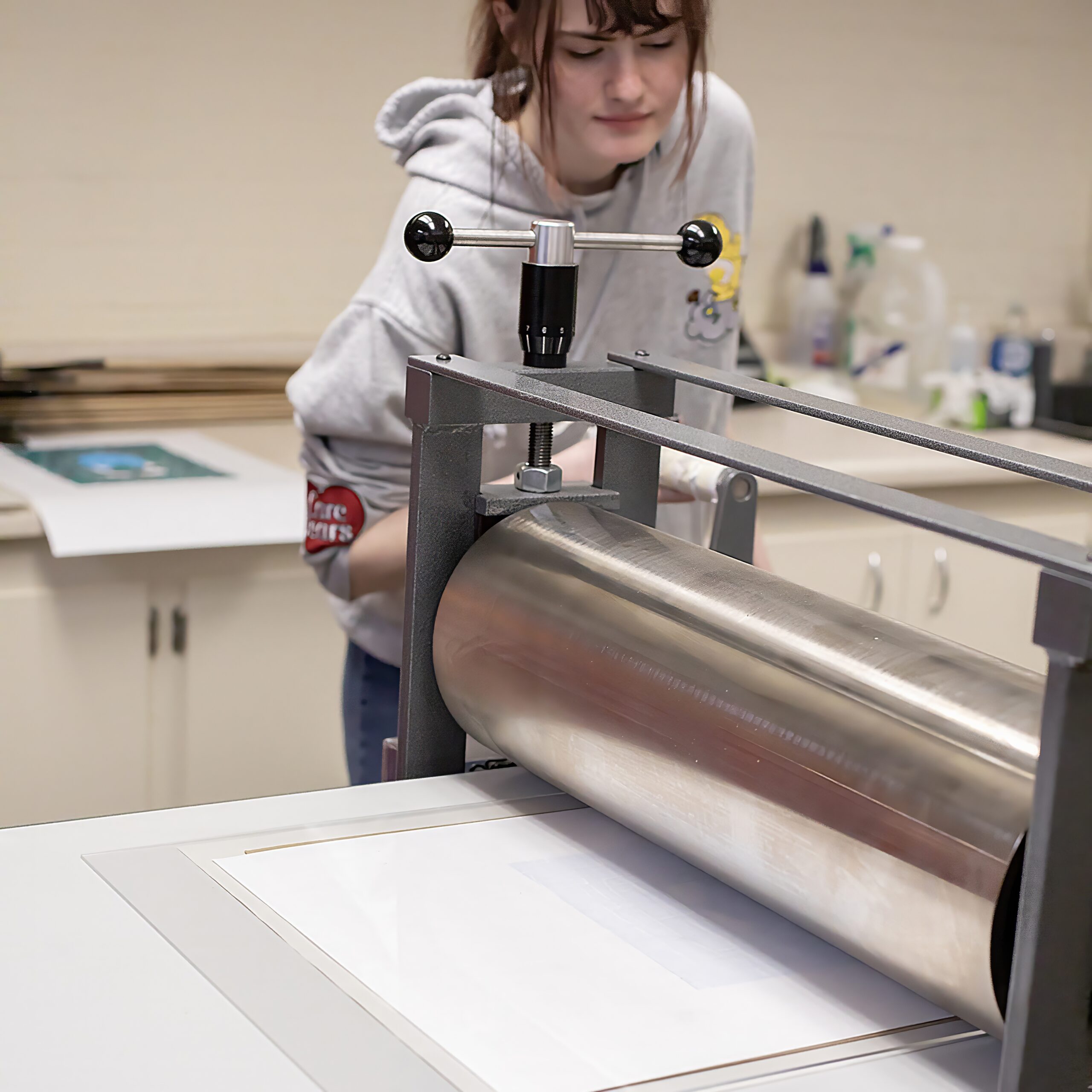 Student using print making machine