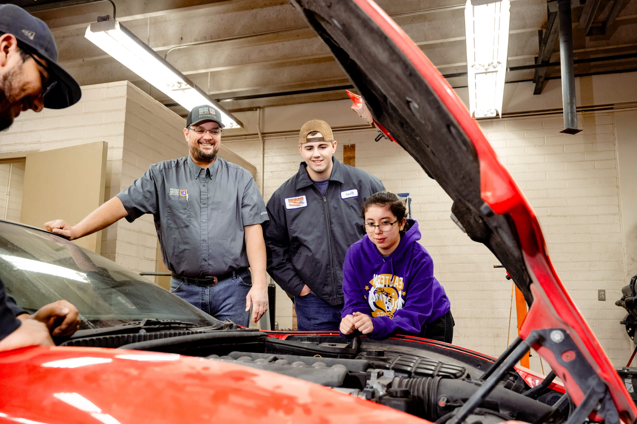 Automotive students working on a car