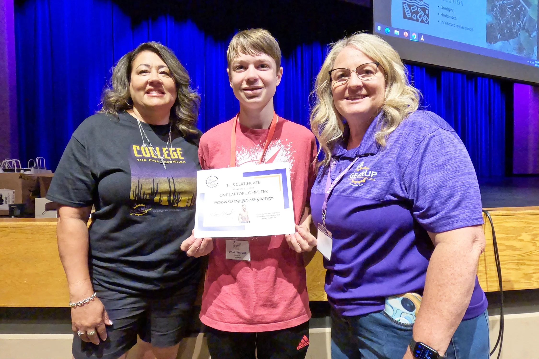 Carolina Gaethje (left) and Mary Wack (right) award Dylan Lunsford, of Payson, a certificate for one of two laptop computers dontated by Justin Gaethje.