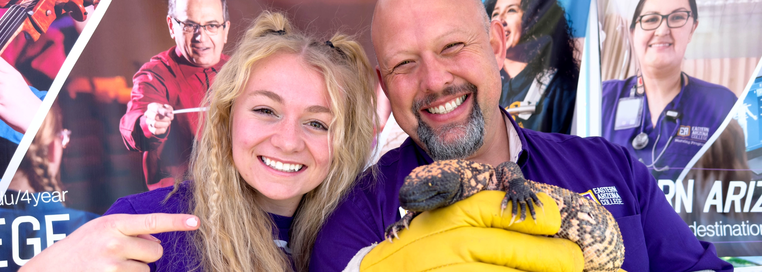 Staff members holding gila monster