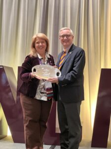 Eastern Arizona College President Todd Haynie accepts the national Pacesetter Award from Virginia Moreland, president of NCMPR.