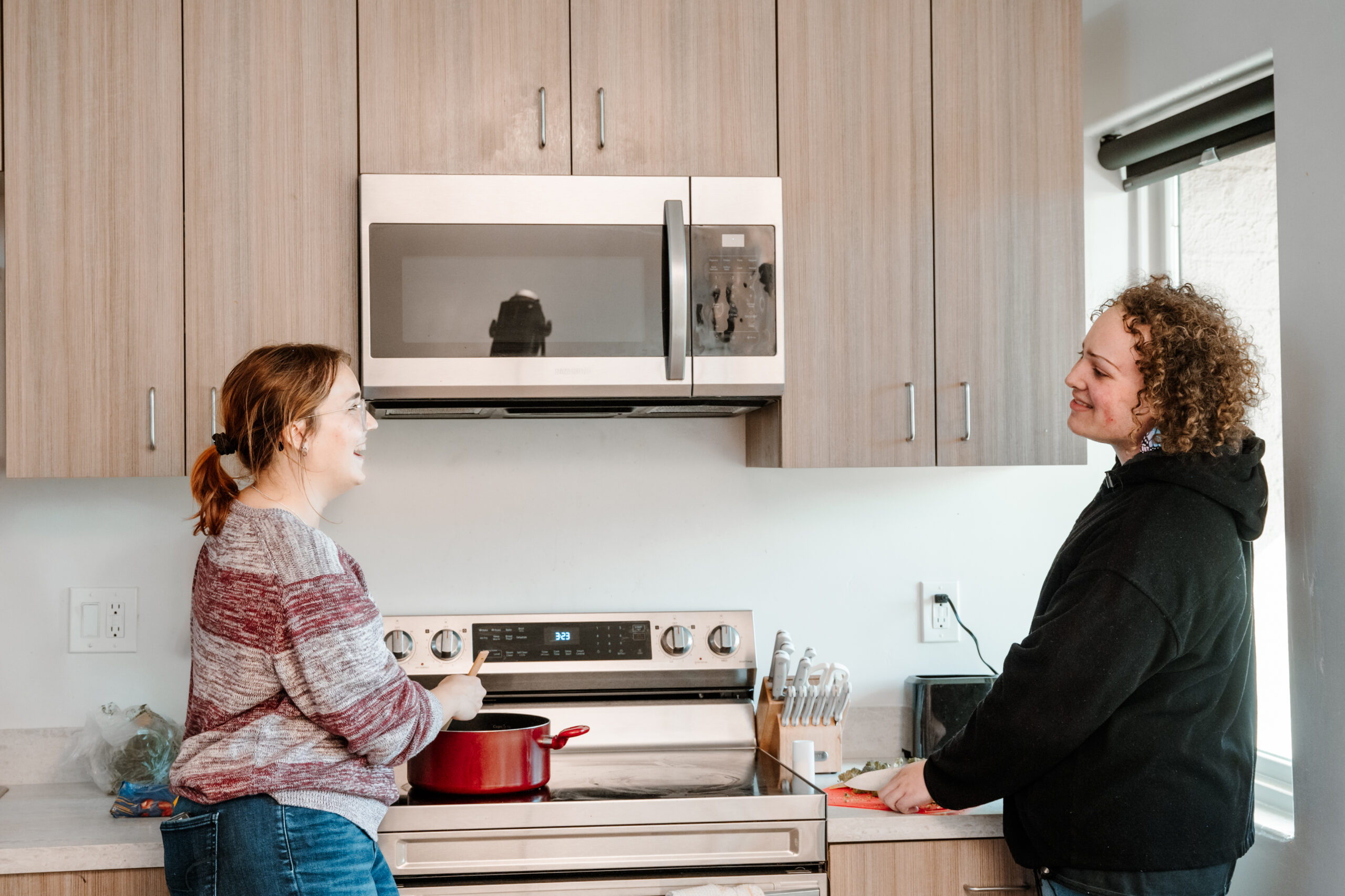 Student residents talking in a kitchen