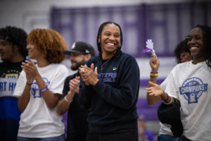 EAC women's basketball team and coach celebrate their win at a pep rally